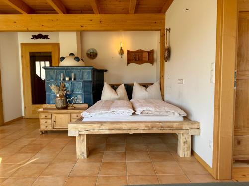 a bedroom with a bed and a bench in a room at Gipfelruhe Ramsau am Dachstein in Ramsau am Dachstein