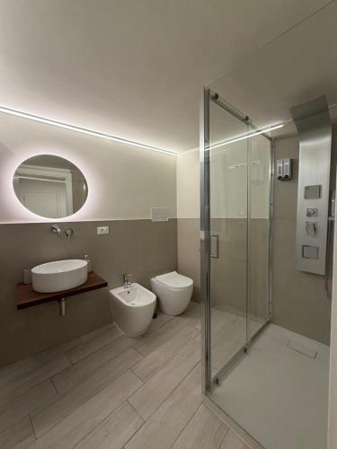 a bathroom with a toilet and a sink and a shower at Seraphia Apartment in Palermo