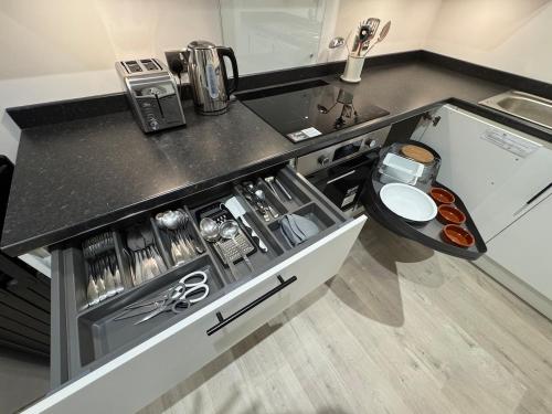 a kitchen with a sink and a counter top at Cosy Modern 2 Beds Chorley Center in Chorley