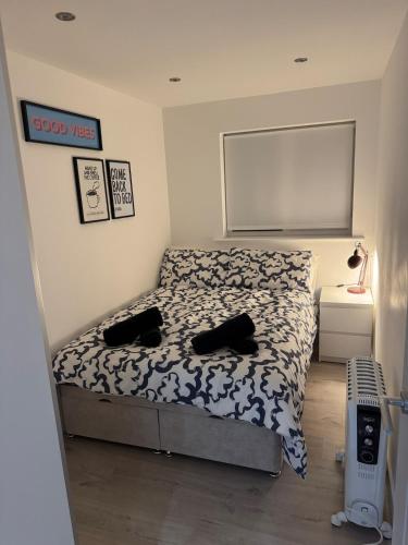 a bedroom with a bed with a black and white comforter at Cosy Modern 2 Beds Chorley Center in Chorley