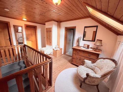 ein Wohnzimmer mit einem Stuhl und einem Spiegel in der Unterkunft Sonnenplatz Appartment Ploninger LANDHAUS in Bad Kleinkirchheim