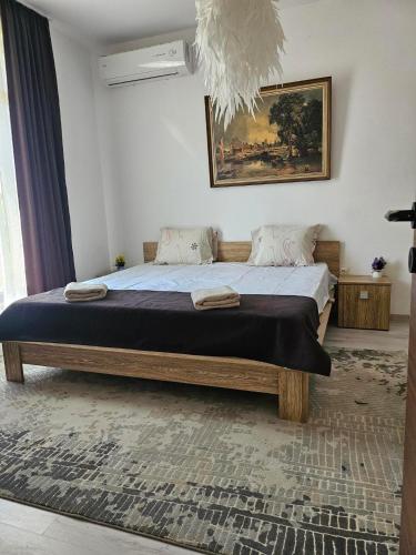 a bedroom with a large bed in a room at Бадевски рай- къща София in Veliko Tŭrnovo