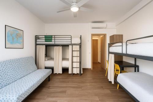 a room with two bunk beds and a couch at Europe Station House in Parma