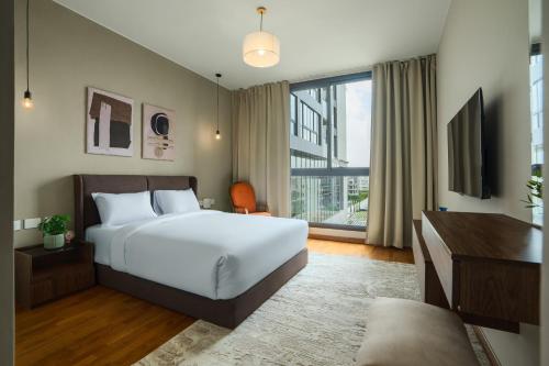 a bedroom with a bed and a large window at Brassbell l Sheikh Zayed l Aeon Towers in Cairo