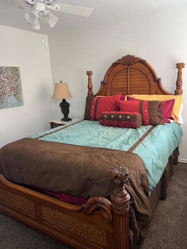 a bedroom with a large wooden bed with colorful pillows at The Bobcat in San Marcos
