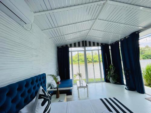 a white room with a blue couch and windows at Feyola`s Leaf in Pelena