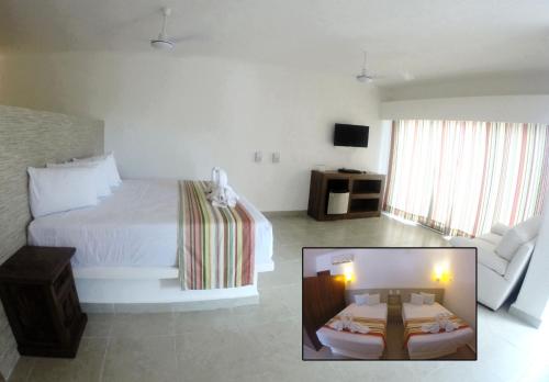 a hotel room with a bed and a couch at Pelicano Inn Playa del Carmen - Beachfront Hotel in Playa del Carmen