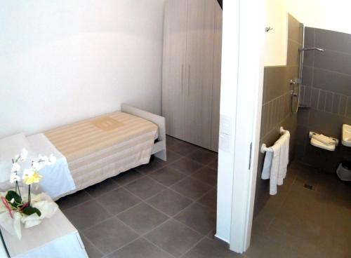 a small room with a bed and a bathroom at Hotel Atlas in Gabicce Mare