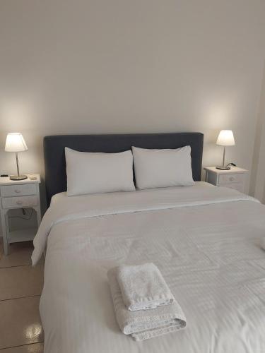a large white bed with a white towel on it at Santa Marina 9 In the center of Ioannina! in Ioannina