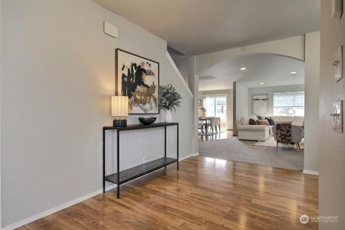 a living room with a table with a lamp on it at Aura in Covington