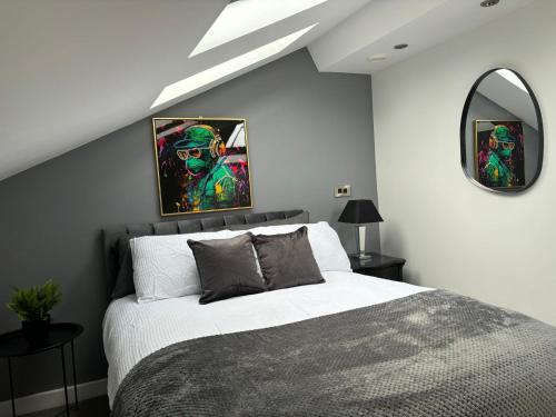 a bedroom with a large bed and a mirror at Stylish Duplex Apartment in Liverpool City Centre in Liverpool