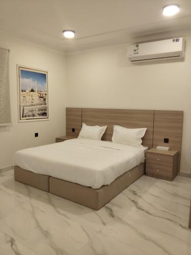 a bedroom with a large bed in a room at قمة قباءلشقق in Al Madinah