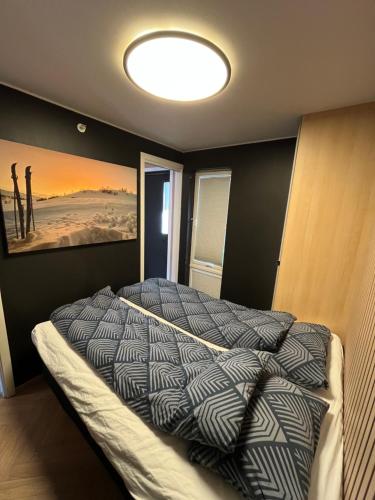 a bedroom with a bed with a painting on the wall at Nice and modern apartment in Stavanger