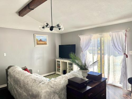 a living room with a couch and a tv at Modern Lux 3BR King Bed in Copperas Cove