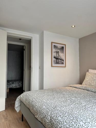 a bedroom with a bed and a picture on the wall at Yamohome in Brussels