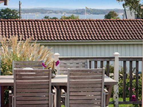 two chairs and a wooden table on a deck at 4 person holiday home in ONSALA-By Traum in Onsala