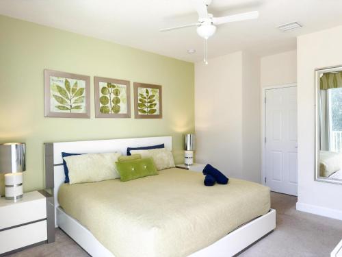 a bedroom with a bed and a ceiling fan at Stylish 3-BR with Private Pool & Conservation View in Orlando