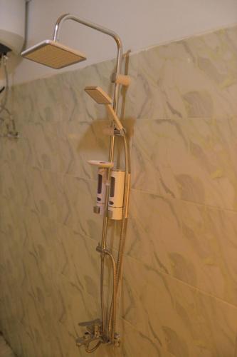 a shower in a bathroom with a shower head at Masa Nubian House in Aswan