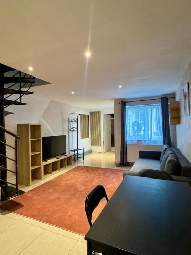 a living room with a couch and a table at Yamohome in Brussels