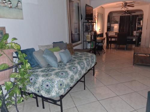 a living room with a couch with blue and white pillows at El Mamey in Miami