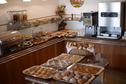 a buffet line with many different types of food at Hotel Colorado Cesenatico in Cesenatico