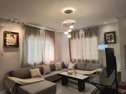 a living room with a couch and a table at Casa Thea Cebu in Talisay