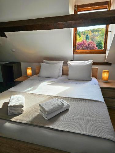 a bedroom with a large bed with two towels on it at Le Cocon - Domaine du Vertendre in Saint-Yrieix-la-Perche