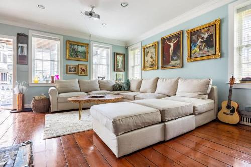 een woonkamer met een bank en een gitaar bij Unique Luxury Central Historic Landmark Home in Lambertville