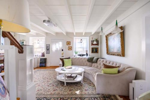 a living room with a couch and a table at Charming & Whimsical Historic River Home in Titusville