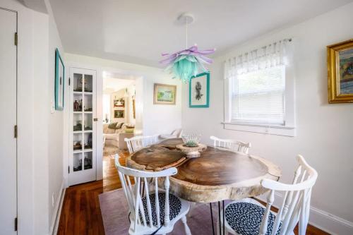 a dining room with a wooden table and chairs at Charming & Whimsical Historic River Home in Titusville