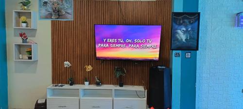 a flat screen tv hanging on a wall at Casa San Ramón in San Ramón