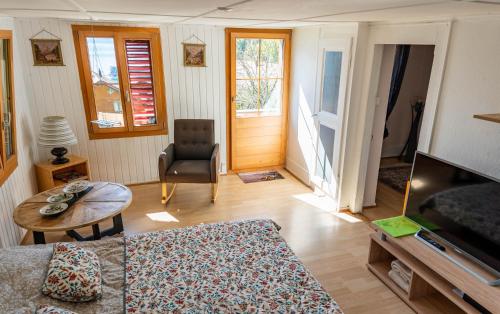 a living room with a couch and a table at Romantic Alpine Farmhouse with Superview of Lake Near Interlaken in Sundlauenen