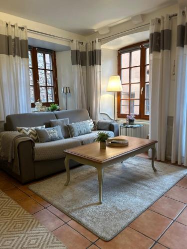 リクヴィールにあるle Roy de coeurのソファとコーヒーテーブルのあるリビングルーム