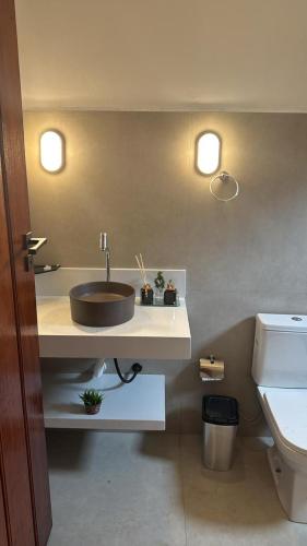 a bathroom with a sink and a toilet at Pousada Green House Paraty in Paraty