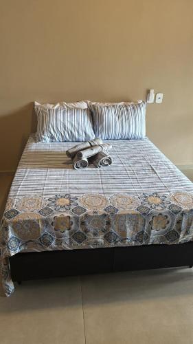 a bed with someones shoes on top of it at Pousada Green House Paraty in Paraty