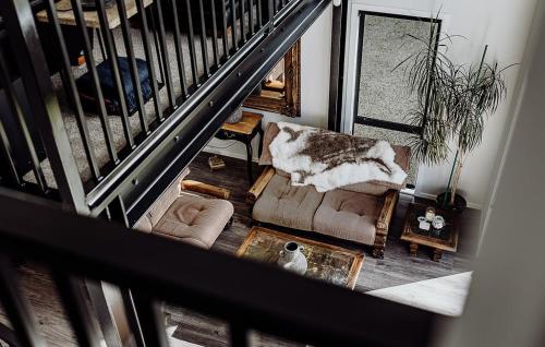 an overhead view of a living room with a staircase at The Black Barn - Panoramic, Private & Luxury in Marsden