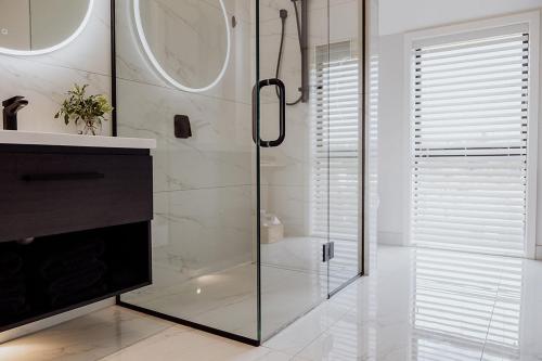 a bathroom with a shower with a glass door at The Black Barn - Panoramic, Private & Luxury in Marsden