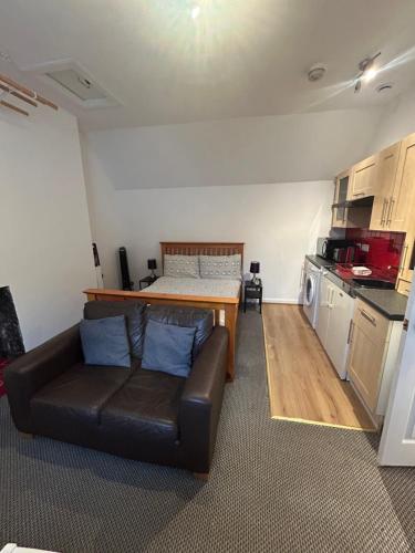 a living room with a couch and a bed at Nevis Bank Studio in Fort William
