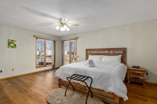 a bedroom with a bed and a ceiling fan at Acreage, 3 King Beds and Ensuites, Dance Floor, Fireplace, AC in Calgary