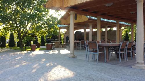 a patio area with a table and chairs at Parish Bull Hotel in Kisvárda
