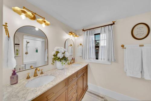 a bathroom with a sink and a mirror at The Brass Tulip in Tulsa