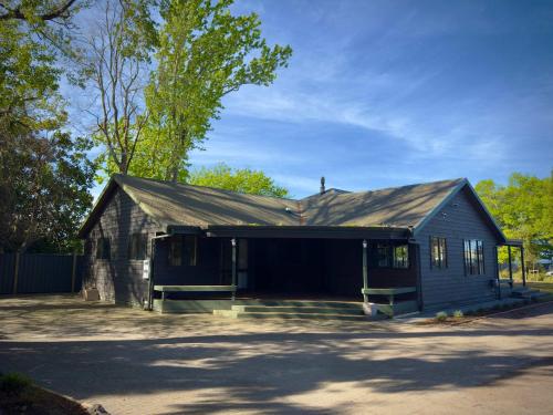 an old building with a gambrel roof at Stillwater Residence - Lakeview Serenity Retreat in Ngongotaha