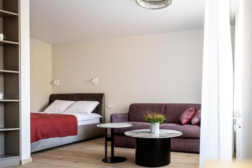 a living room with a couch and a table at Vytauto 12 in Marijampolė