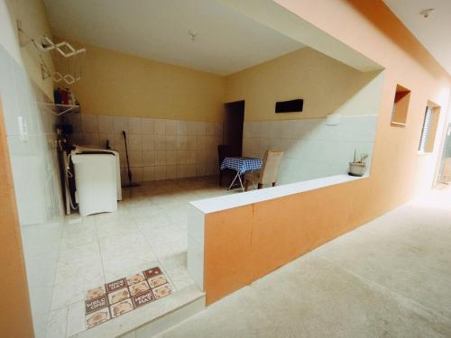 a room with a kitchen with a refrigerator in it at Refúgio Estação in Guararema