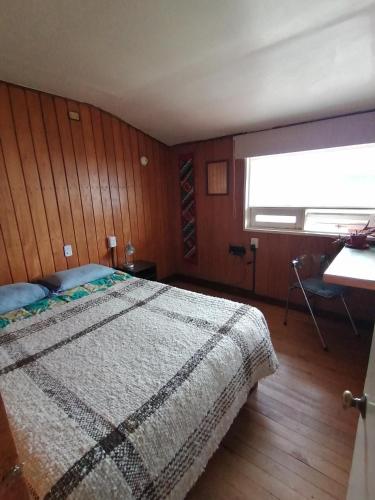 a bedroom with a large bed and a window at Habitación privada en Puerto Varas in Puerto Varas