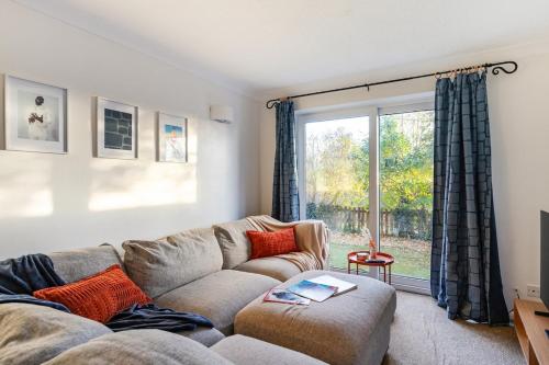 a living room with a couch and a window at Cosy 2-Bed Maisonette in Ashford in Kennington
