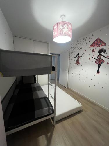 a bedroom with a bunk bed and a wall with a mural at Quiet and Spacious 2BR And Salon Terrasse Parking in Saint-Denis