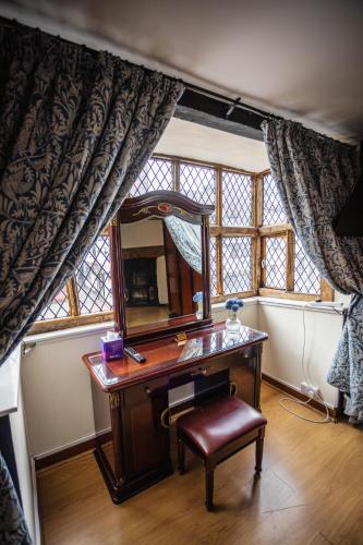 a desk with a mirror and a chair in a room at Five Guest Rooms in Tudor House Short Lets & Serviced Accommodation Frankwell Shrewsbury With Free WiFi in Shrewsbury