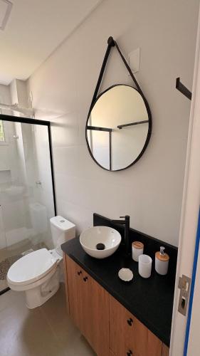 a bathroom with a sink and a mirror on the wall at palmas beach in Governador Celso Ramos