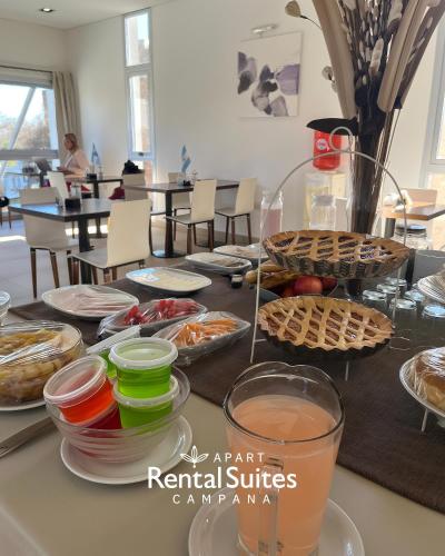 a table topped with plates of food on a table at RENTAL SUITES CAMPANA in Campana